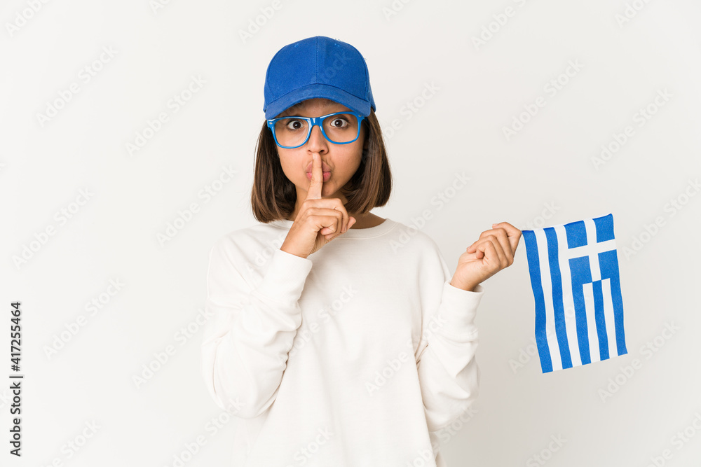 Young hispanic mixed race woman holding a greece flag keeping a secret or asking for silence.