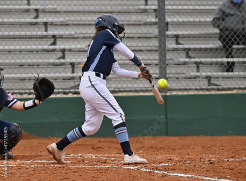 Girls in action playing in a softball game