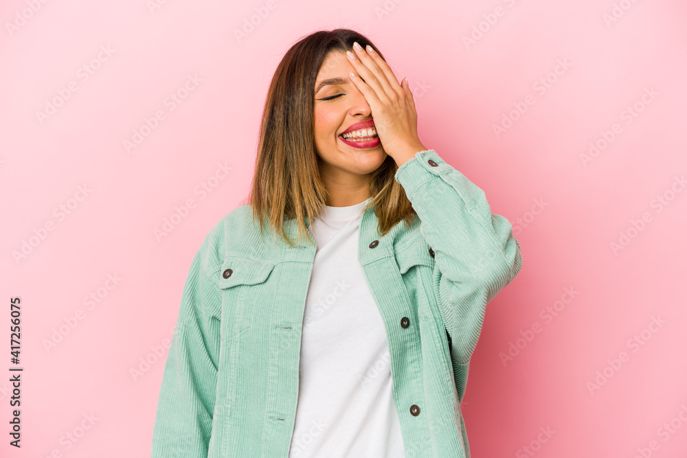 Young indian woman isolated on pink background laughing happy, carefree, natural emotion. Young indian woman isolated on pink background laughing happy, carefree, natural emotion.