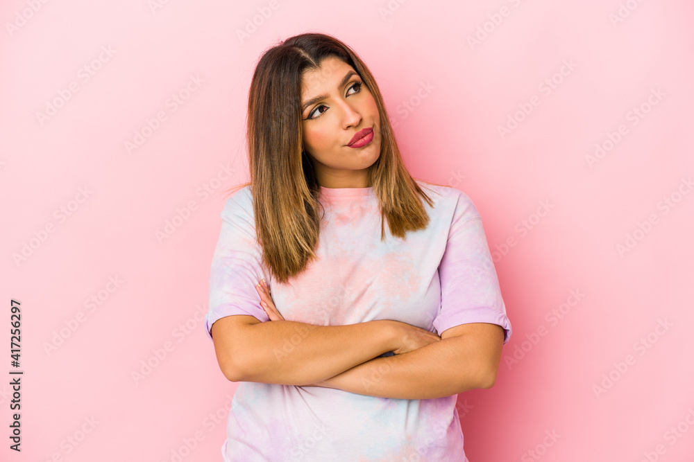Young indian woman isolated on pink background dreaming of achieving goals and purposes Young indian woman isolated on pink background dreaming of achieving goals and purposes