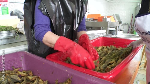 Karpathos Greece an old recipe of fish marinated in a Christian holiday here women prepare it for the whole village