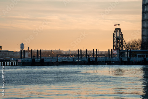 Jersey City, NJ - USA - Feb. 27, 2021: Landscape view of iconic the Colgate Clock at sunset. It's an octagonal clock facing the Hudson River near Exchange Place in Jersey City, New Jersey. photo