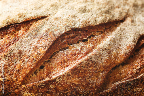 Details of cuts in a sourdough bread's crust.