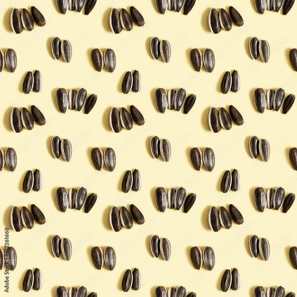 Black sunflower seeds on beige background. Raw whole grains, organic healthy food Black sunflower seeds on beige background. Raw whole grains, organic healthy food