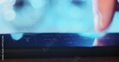 Man enters pin-code pressing keys by finger to unblock screen of contemporary mobile phone on blurred background macro view photo