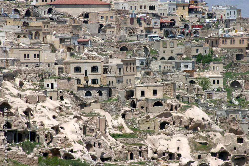 Special stone formation and houses near the Uchisar Castle in Cappadocia, Nevsehir, Turkey. Cappadocia is part of the UNESCO World Heritage Site.