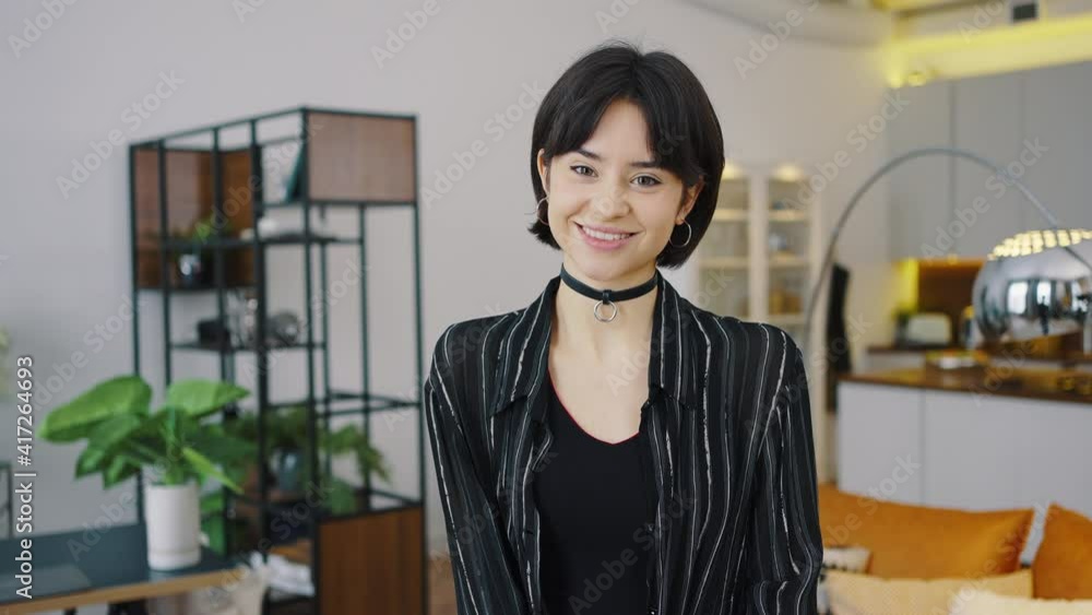 Closeup of young female with beautiful face, millennial woman looking at camera, smiling pretty girl wearing casual clothes and stylish costume jewelry, business woman concept