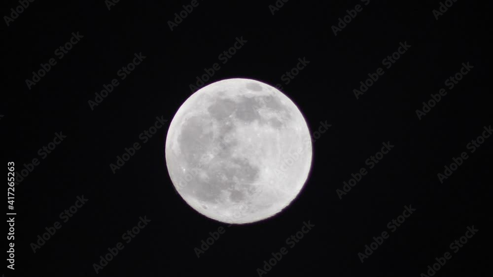 The full moon moves quickly in the dark sky. Werewolf full moon. Dramatic sky view, time lapse The full moon moves quickly in the dark sky. Werewolf full moon. Dramatic sky view, time lapse