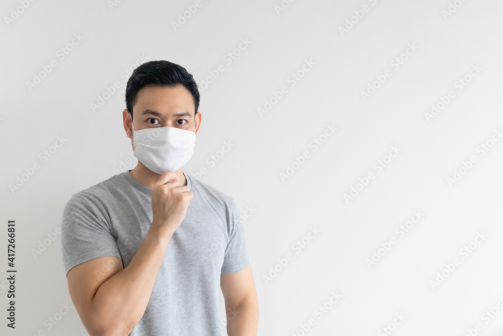 Asian man in white mask presenting the empty copy space on isolated background. Asian man in white mask presenting the empty copy space on isolated background.