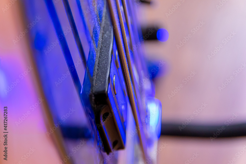 Elements and parts of the bass guitar close-up. Macro. Soft Focus