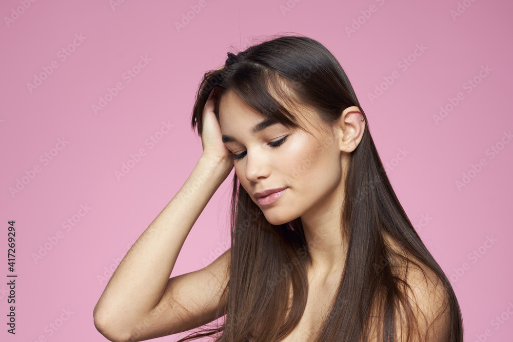 Pretty brunette naked shoulders clear skin pink background Pretty brunette naked shoulders clear skin pink background