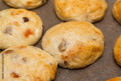 Close-up of cottage cheese pancakes on baking paper on a pan, just taken out of the oven. 