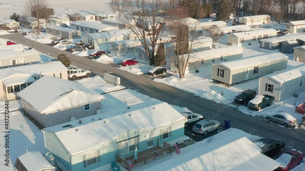 Aerial of prefabricated mobile home, trailer park covered in winter snow in rural USA, Appalachia. Aerial of prefabricated mobile home, trailer park covered in winter snow in rural USA, Appalachia.