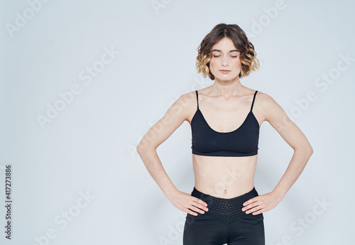 Woman in sportswear keeps her hands on the belt Fitness Model