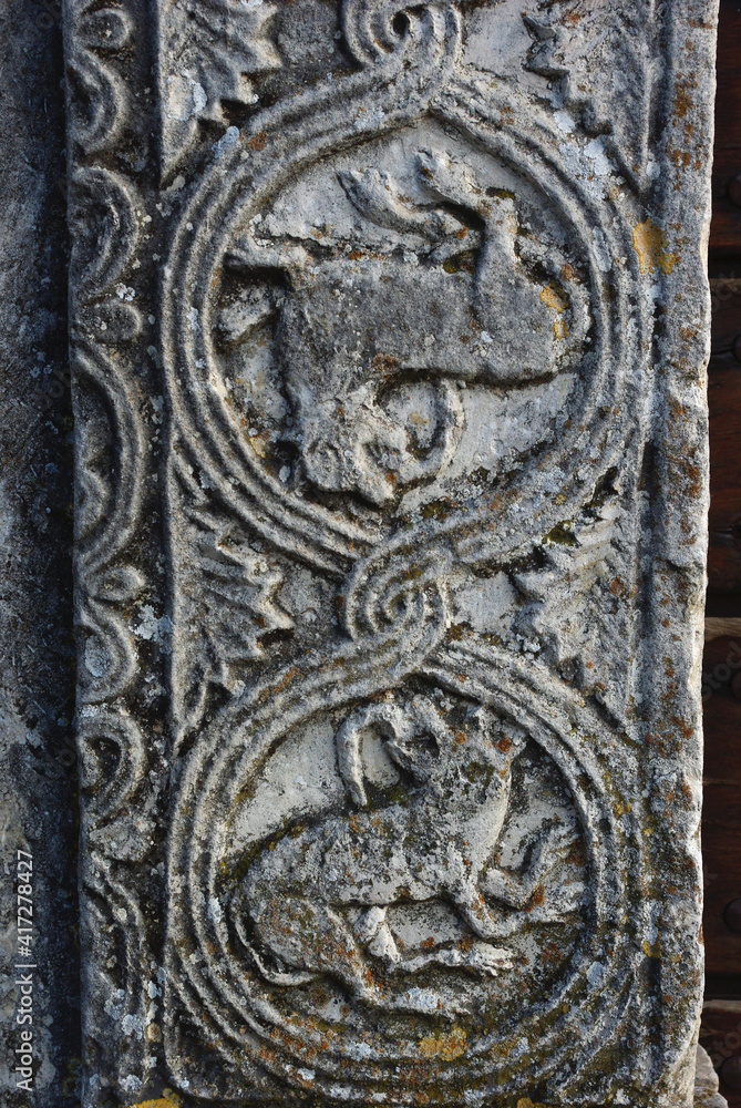 Moscufo - Abruzzo - Abbey of Santa Maria del Lago - Side detail of the portal with flat relief elements.