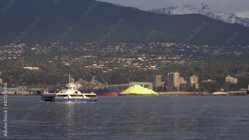 SeaBus Ferry Sailing From Vancouver To North Vancouver With City On The Background. wide shot SeaBus Ferry Sailing From Vancouver To North Vancouver With City On The Background. wide shot