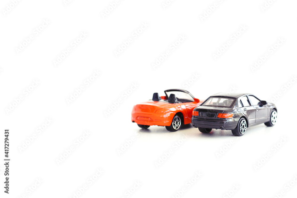 Two model toy cars isolated on white background suggesting automotive industry concept