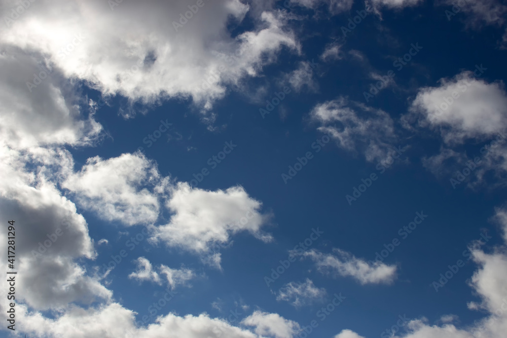 Cloudy day, white clouds in the blue sky, scattered clouds.