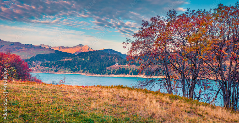 Landscape photography. Panoramic autumn view of Roselend lake/Lac de Roselend. Majestic morning scene of Auvergne-Rhone-Alpes, France, Europe. Beauty of nature concept background.