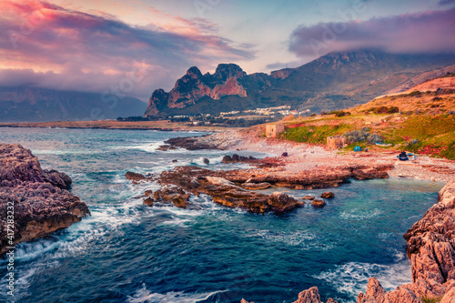 Colorful spring sunrise on Sicily, Isolidda Beach, San Vito cape, Italy, Europe. Spectacular morning seascape of Mediterranean sea. Beauty of nature concept background.