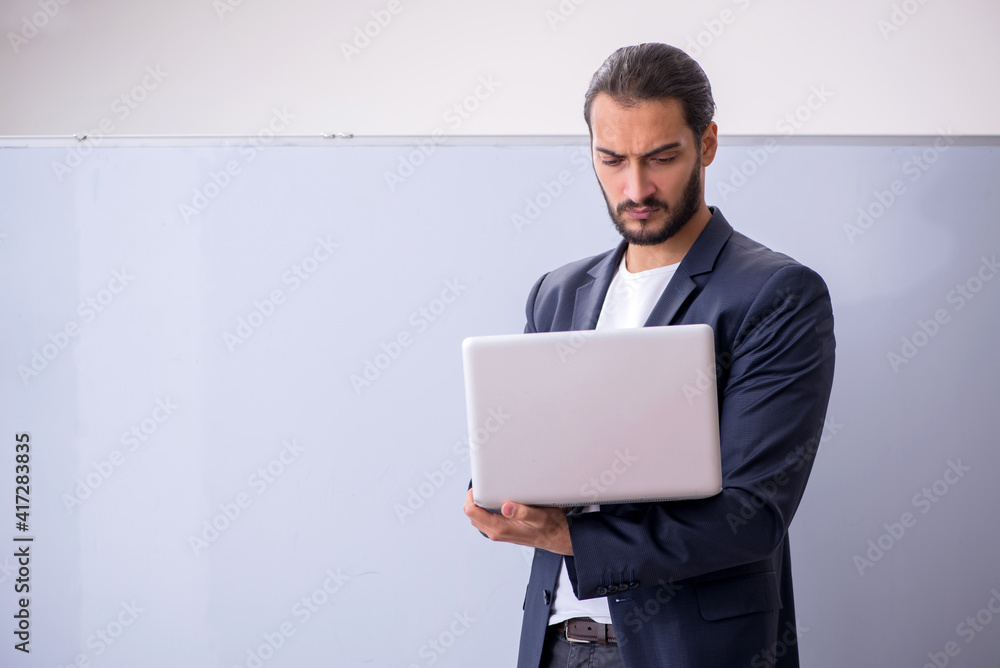 Young male teacher in tele-studying concept Young male teacher in tele-studying concept