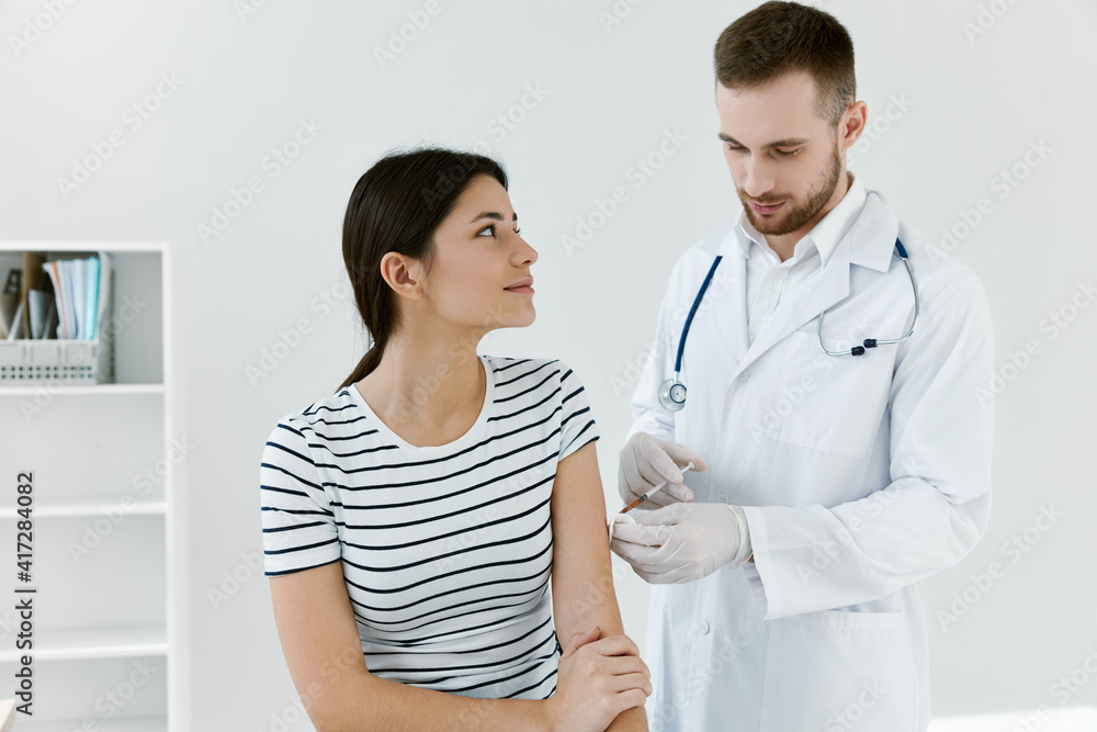 male doctor giving an injection to a patient coronavirus vaccination male doctor giving an injection to a patient coronavirus vaccination