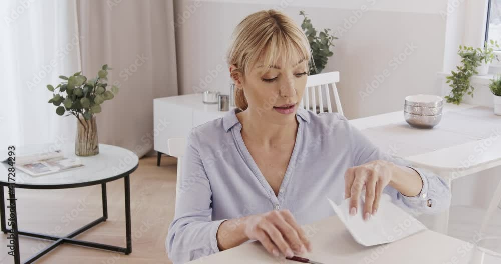 Good news. Opening the letter, the woman opens the envelope. Happy, smiling woman opens a letter. Good news. Opening the letter, the woman opens the envelope. Happy, smiling woman opens a letter.