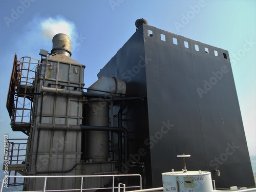 View of a ships funnel with an external scrubber system to reduce the excess sulfur content from the exhaust gases 