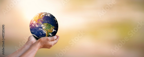 Fototapeta Naklejka Na Ścianę i Meble -  A man holding earth globe in his hands with blur backgrounds, world environment day concept, elements of this image furnished by NASA.
