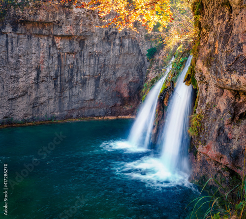 Beautiful autumn scenery. Splendid morning scene of waterfall in deep canyon. Exciting autumn scene of Plitvice National Park, Croatia, Europe. Abandoned places of Plitvice lakes series.