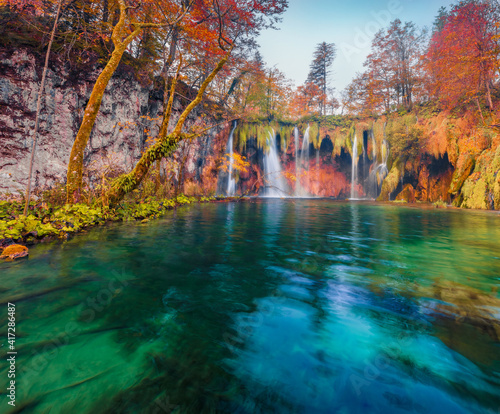 Beautiful autumn scenery. Splendid morning view of pure water waterfall in Plitvice National Park. Stunning autumn scene of Croatia  Europe. Beauty of nature concept background.
