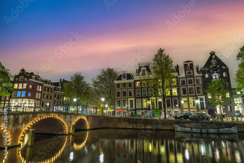 Amsterdam Netherlands, night city skyline of Dutch house at canal waterfront