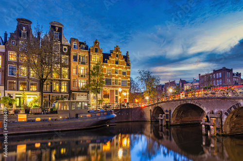 Amsterdam Netherlands, night city skyline of Dutch house at canal waterfront