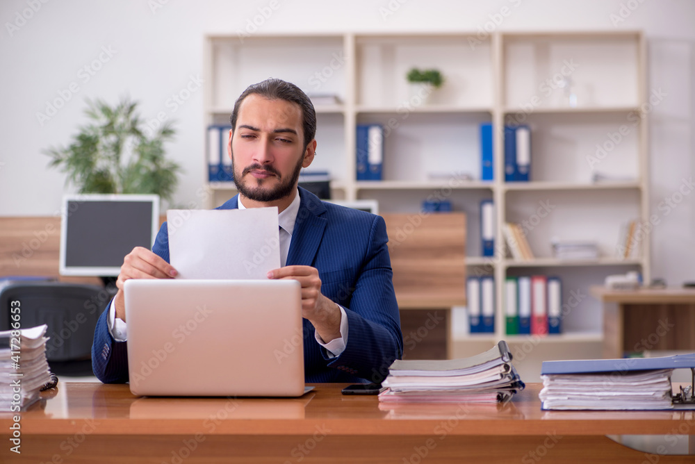 Young businessman employee working at workplace Young businessman employee working at workplace