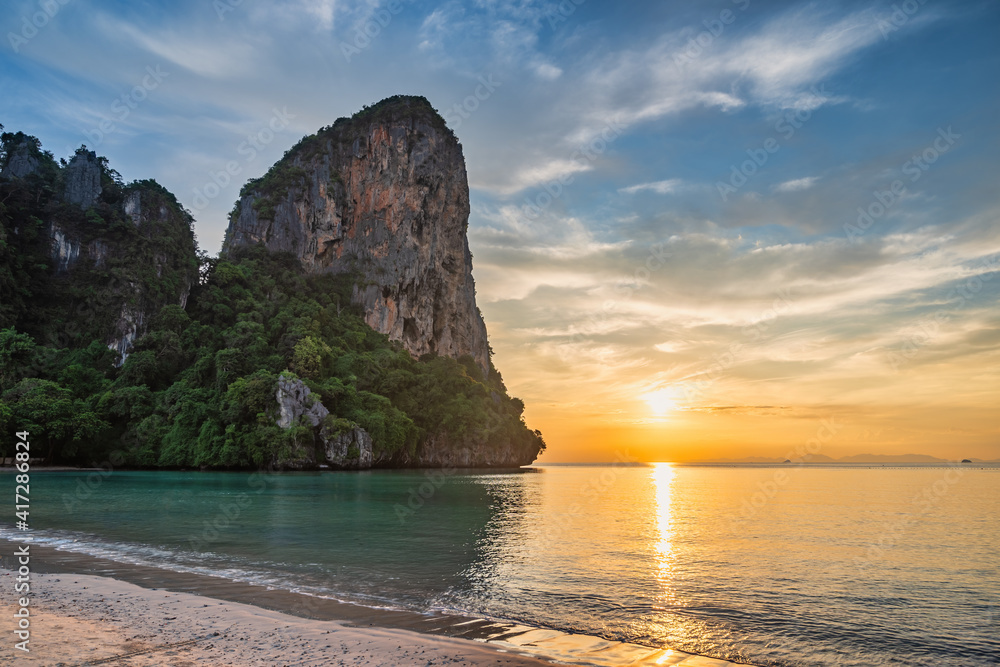 Tropical islands sunset view with ocean blue sea water and white sand beach at Railay Beach, Krabi Thailand nature landscape
