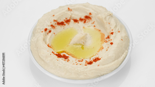 plate of hummus with smoked paprika and olive oil on white background. Healthy vegan food