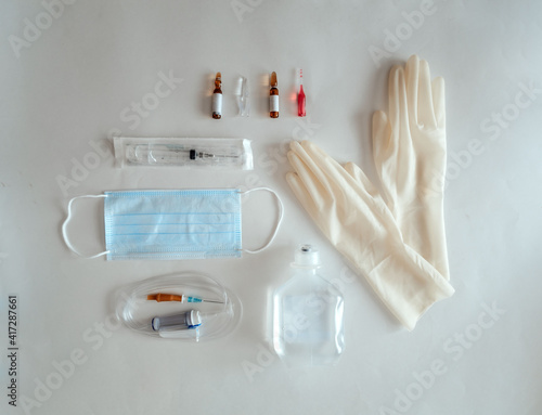 Foto Flat lay with medical items: glaves, mask, syringe, ampoules