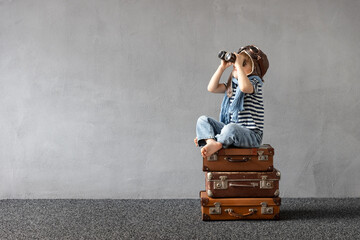 Happy child dreaming about summer vacation and travel