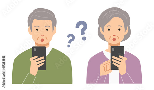 スマホを操作する疑問顔の高齢者