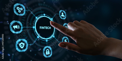 Fintech -financial technology concept.Young businessman select the icon Fintech on the virtual display.