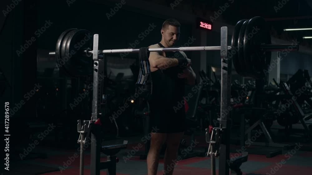 Young powerlifter in gym. Preparing for exercise Young powerlifter in gym. Preparing for exercise