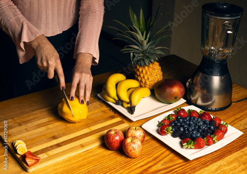 Girl cutting a mango for a smoothie