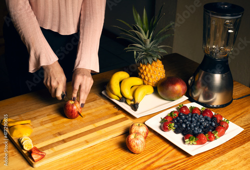 Girl cutting an apple for a smoothie