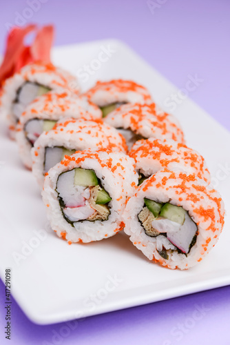 Maki Sushi - Roll made of smoked salmon and cream cheese. Traditional Japanese cuisine concept, over purple background.