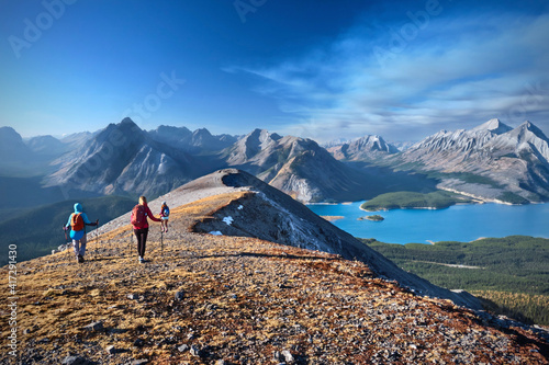 Group of people walking on rocks above the lake in the Canadian Rockies. Spray Lake Park.  Alberta. Canada photo