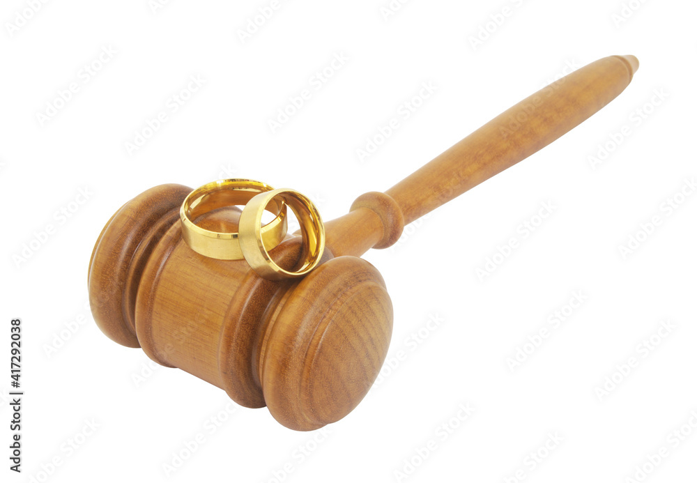 Two wedding rings and wooden  gavel isolated on white background. 