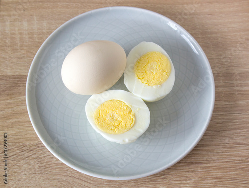 an egg cut in half and a whole egg