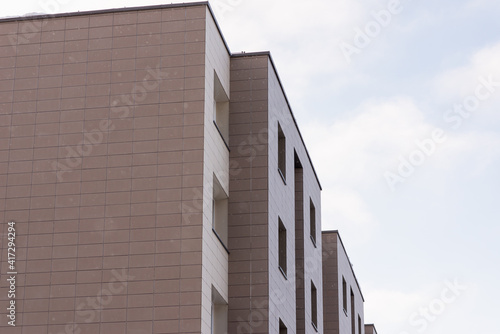 Fragment residential apartment with flat building exterior. Detail of New luxury house and home complex.