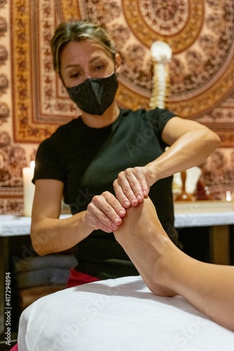 Masseuse giving a foot massage to a client