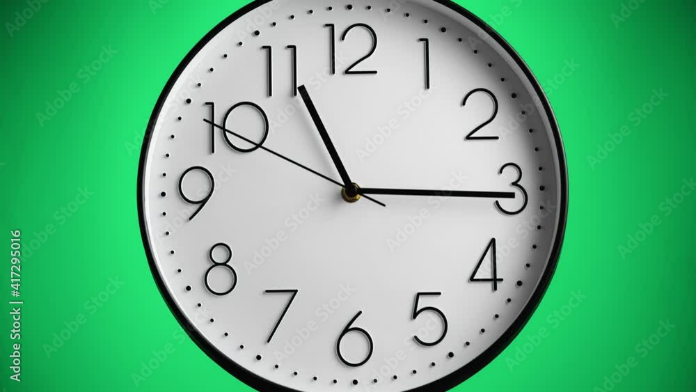 White wall clock on green background. One hour to 12, time-lapse. Time concept. White wall clock on green background. One hour to 12, time-lapse. Time concept.